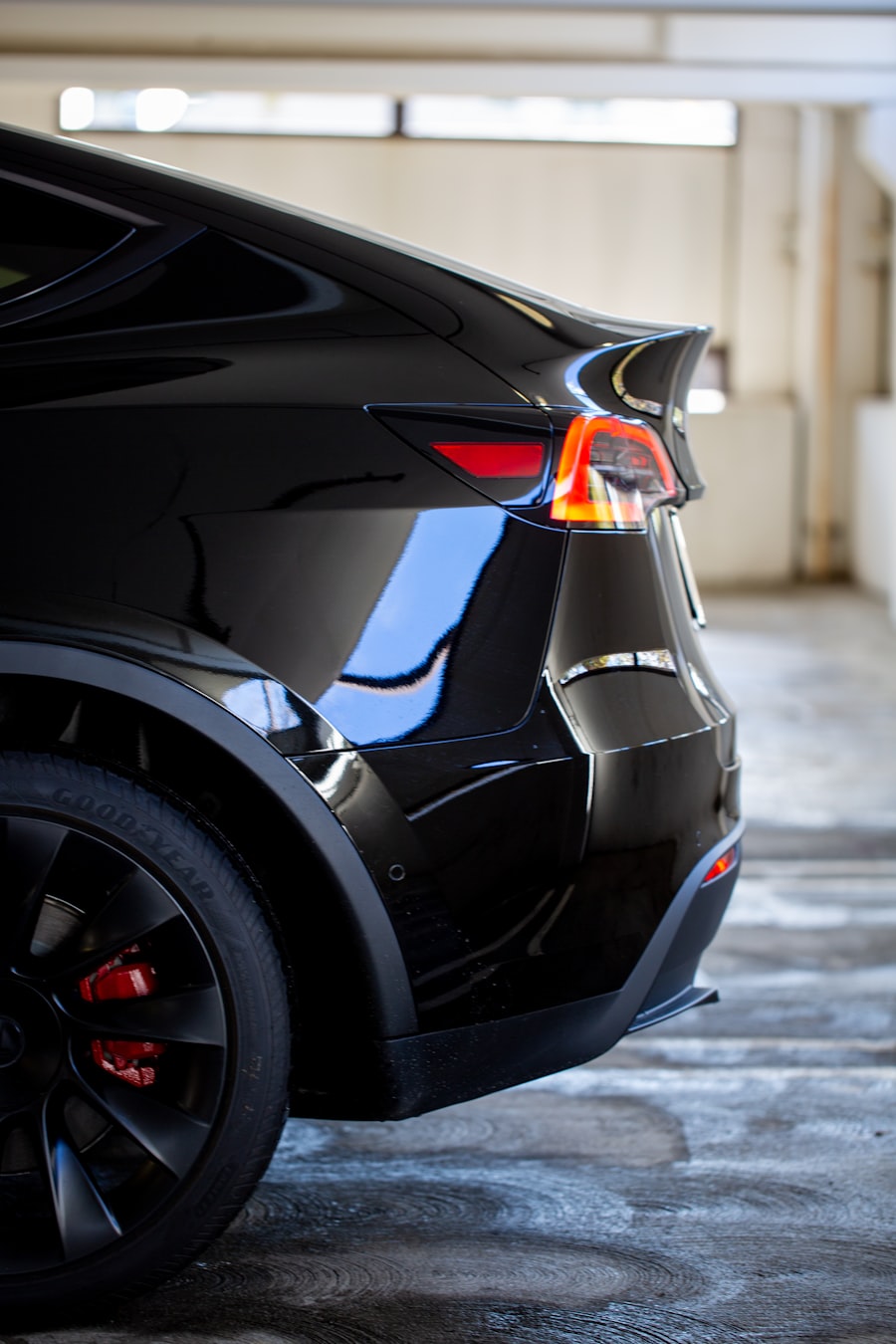 A black Tesla parked on a concrete surface