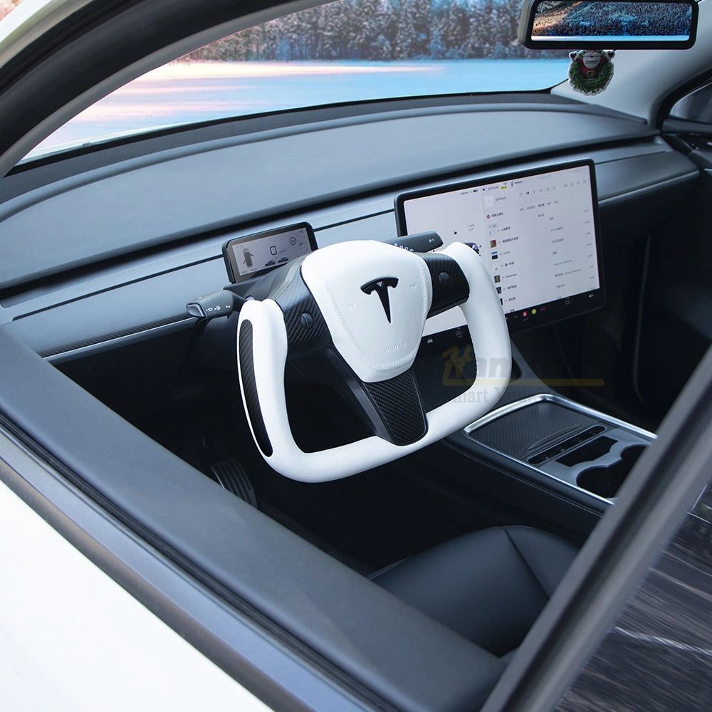 A white yoke steering wheel installed in a Tesla interior